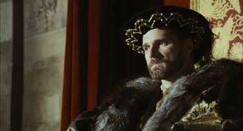 Movie still from “The Other Boleyn Girl” (2008), directed by Justin Chadwick – A man wearing a fur coat and a crown; Close Up shot, Over the shoulder angle
