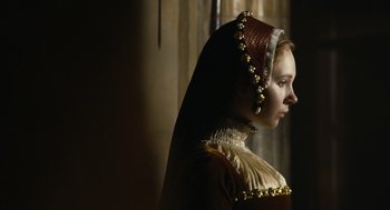 Movie still from “The Other Boleyn Girl” (2008), directed by Justin Chadwick – A woman in a red dress and a gold headpiece; Close Up shot, Over the shoulder angle
