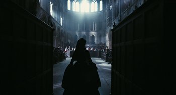 Movie still from “The Other Boleyn Girl” (2008), directed by Justin Chadwick – A woman sitting in the middle of an aisle in a church; Extreme Wide shot, Low angle