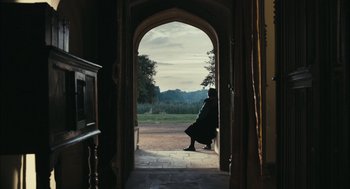 Movie still from “The Other Boleyn Girl” (2008), directed by Justin Chadwick – A person sitting on a bench looking out a doorway; Wide shot, Over the shoulder angle