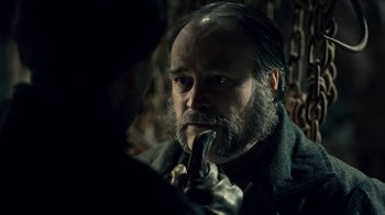 Movie still from “Guillermo del Toro's Cabinet of Curiosities” (2022), directed by Keith Thomas – A man with a beard is looking at himself in the mirror; Close Up shot, Over the shoulder angle