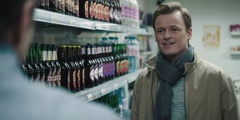 Movie still from “The Ritual” (2017), directed by David Bruckner – A man standing in front of a shelf of beer; Close Up shot, Over the shoulder angle