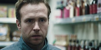 Movie still from “The Ritual” (2017), directed by David Bruckner – A person wearing a blue shirt; Close Up shot, Over the shoulder angle
