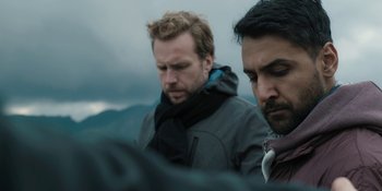 Movie still from “The Ritual” (2017), directed by David Bruckner – Two men standing next to each other on a hill; Close Up shot, Over the shoulder angle