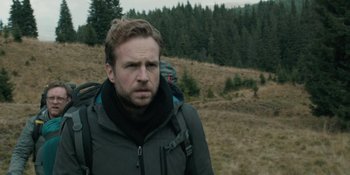 Movie still from “The Ritual” (2017), directed by David Bruckner – A person with a backpack; Close Up shot, Over the shoulder angle