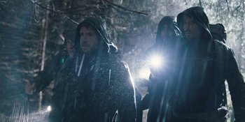 Movie still from “The Ritual” (2017), directed by David Bruckner – A group of people standing next to each other in the snow; Medium shot, Low angle