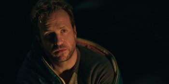 Movie still from “The Ritual” (2017), directed by David Bruckner – A person sitting in a chair; Close Up shot, Over the shoulder angle