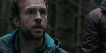 Movie still from “The Ritual” (2017), directed by David Bruckner – A person wearing a jacket; Close Up shot, Over the shoulder angle