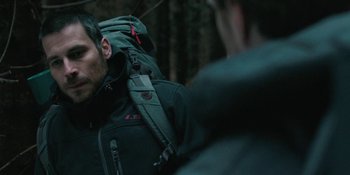Movie still from “The Ritual” (2017), directed by David Bruckner – A man with a backpack in the woods; Close Up shot, Over the shoulder angle