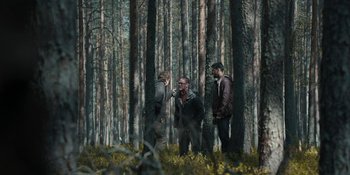 Movie still from “The Ritual” (2017), directed by David Bruckner – A group of people standing in a forest; Wide shot, Over the shoulder angle