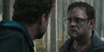 Movie still from “The Ritual” (2017), directed by David Bruckner – Two men are facing each other in the woods; Close Up shot, Over the shoulder angle