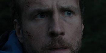 Movie still from “The Ritual” (2017), directed by David Bruckner – A man's face with blood all over it; Extreme Close Up shot, Low angle