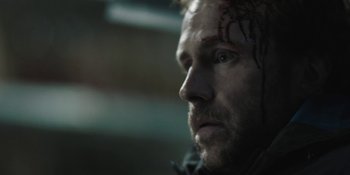 Movie still from “The Ritual” (2017), directed by David Bruckner – A person looking at the camera; Close Up shot, Over the shoulder angle