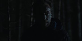 Movie still from “The Ritual” (2017), directed by David Bruckner – A person with a face covered in blood; Close Up shot, Low angle