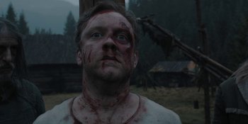 Movie still from “The Ritual” (2017), directed by David Bruckner – A person with blood all over his face; Close Up shot, Low angle
