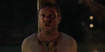 Movie still from “The Ritual” (2017), directed by David Bruckner – A person with blood all over his face; Close Up shot, Over the shoulder angle
