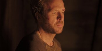 Movie still from “The Ritual” (2017), directed by David Bruckner – A person looking at the camera; Close Up shot, Over the shoulder angle