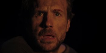 Movie still from “The Ritual” (2017), directed by David Bruckner – A person looking at the camera; Close Up shot, Over the shoulder angle