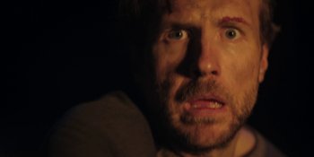 Movie still from “The Ritual” (2017), directed by David Bruckner – A person with a bandage on his face; Close Up shot, Low angle
