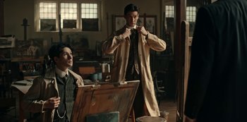 Movie still from “Guillermo del Toro's Cabinet of Curiosities” (2022), directed by Keith Thomas – A man standing next to another man in a room; Medium shot, Over the shoulder angle