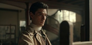 Movie still from “Guillermo del Toro's Cabinet of Curiosities” (2022), directed by Keith Thomas – A person wearing a suit and neck tie; Close Up shot, Low angle