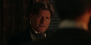 Movie still from “Guillermo del Toro's Cabinet of Curiosities” (2022), directed by Keith Thomas – A person wearing a suit and tie; Close Up shot, Over the shoulder angle