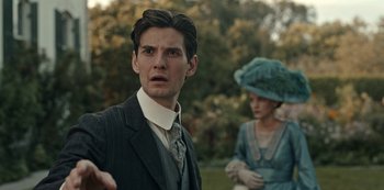 Movie still from “Guillermo del Toro's Cabinet of Curiosities” (2022), directed by Keith Thomas – A man and a woman standing next to each other in a field; Close Up shot, Over the shoulder angle
