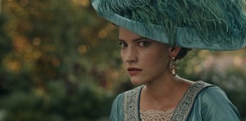 Movie still from “Guillermo del Toro's Cabinet of Curiosities” (2022), directed by Keith Thomas – A woman in a blue hat and a dress; Close Up shot, Over the shoulder angle