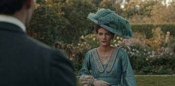 Movie still from “Guillermo del Toro's Cabinet of Curiosities” (2022), directed by Keith Thomas – A woman wearing a blue dress and a hat; Close Up shot, Over the shoulder angle