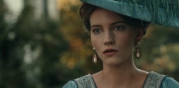 Movie still from “Guillermo del Toro's Cabinet of Curiosities” (2022), directed by Keith Thomas – A beautiful young lady wearing a blue dress and a hat; Close Up shot, Over the shoulder angle