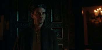 Movie still from “Guillermo del Toro's Cabinet of Curiosities” (2022), directed by Keith Thomas – A person wearing a sweater near a wall; Close Up shot, Over the shoulder angle