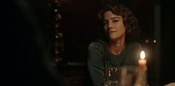 Movie still from “Guillermo del Toro's Cabinet of Curiosities” (2022), directed by Keith Thomas – A woman sitting at a table with a glass of wine; Close Up shot, Over the shoulder angle