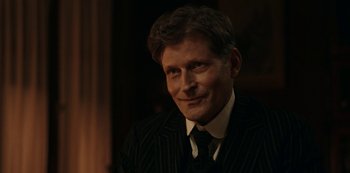 Movie still from “Guillermo del Toro's Cabinet of Curiosities” (2022), directed by Keith Thomas – A person wearing a suit and tie; Close Up shot, Over the shoulder angle