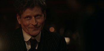 Movie still from “Guillermo del Toro's Cabinet of Curiosities” (2022), directed by Keith Thomas – A person wearing a suit and tie; Close Up shot, Over the shoulder angle