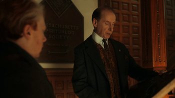 An older man wearing a suit and tie