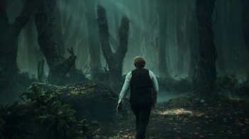 Movie still from “Guillermo del Toro's Cabinet of Curiosities” (2022), directed by Keith Thomas – A man walking through the woods in the rain; Wide shot, Low angle