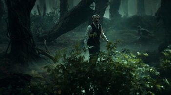 Movie still from “Guillermo del Toro's Cabinet of Curiosities” (2022), directed by Keith Thomas – A man walking through the woods in the rain; Wide shot, Over the shoulder angle