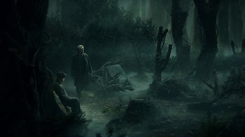Movie still from “Guillermo del Toro's Cabinet of Curiosities” (2022), directed by Keith Thomas – Two people are walking through the woods in the dark; Wide shot, High angle