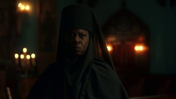 Movie still from “Guillermo del Toro's Cabinet of Curiosities” (2022), directed by Keith Thomas – A woman wearing a black robe and a black hat; Close Up shot, Low angle