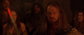 Movie still from “The Scorpion King” (2002), directed by Chuck Russell – A man with long hair and a goatee stares at the camera; Close Up shot, Over the shoulder angle