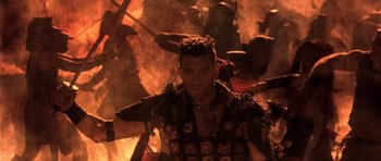 Movie still from “The Scorpion King” (2002), directed by Chuck Russell – A man in a costume is walking through a fire; Medium shot, Low angle