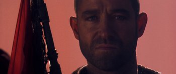 Movie still from “The Scorpion King” (2002), directed by Chuck Russell – A person holding a gun; Close Up shot, Low angle