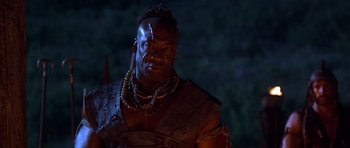 Movie still from “The Scorpion King” (2002), directed by Chuck Russell – A man with a beard is wearing a necklace; Close Up shot, Low angle