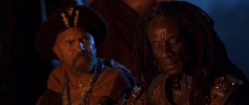 Movie still from “The Scorpion King” (2002), directed by Chuck Russell – A man and a woman sitting next to each other in a room; Close Up shot, Over the shoulder angle