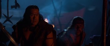 Movie still from “The Scorpion King” (2002), directed by Chuck Russell – A man and a woman are sitting in the dark; Close Up shot, Over the shoulder angle