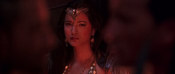 Movie still from “The Scorpion King” (2002), directed by Chuck Russell – A beautiful woman with long black hair wearing a headpiece; Close Up shot, Over the shoulder angle