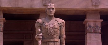 Movie still from “The Scorpion King” (2002), directed by Chuck Russell – A statue of a man holding a staff in his hand; Medium shot, Low angle