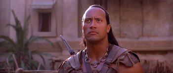 Movie still from “The Scorpion King” (2002), directed by Chuck Russell – A person with a sword in his hand; Close Up shot, Low angle
