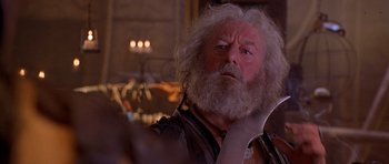 Movie still from “The Scorpion King” (2002), directed by Chuck Russell – An old man with a long white beard looks to his left; Close Up shot, Over the shoulder angle