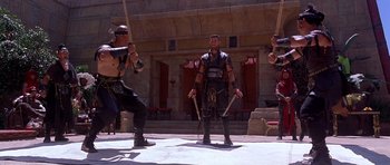 Movie still from “The Scorpion King” (2002), directed by Chuck Russell – A group of men standing next to each other on a stage; Wide shot, Low angle
